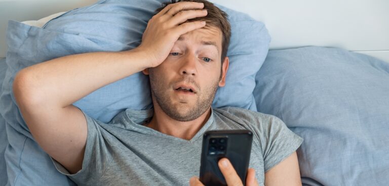 Brainrot, man in bed staring at mobile phone