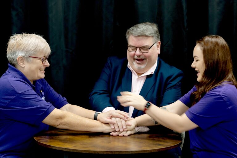 Barry Clarke with Fiona Scott (camera left) and Lauren Roberts, both of Scott Media