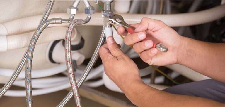 plumber working in bathroom